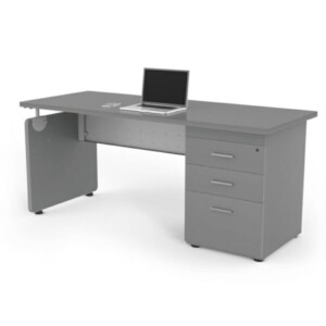 Escritorio 716 con cajonera color ceniza, está de lado el escritorio y tiene una computadora encima